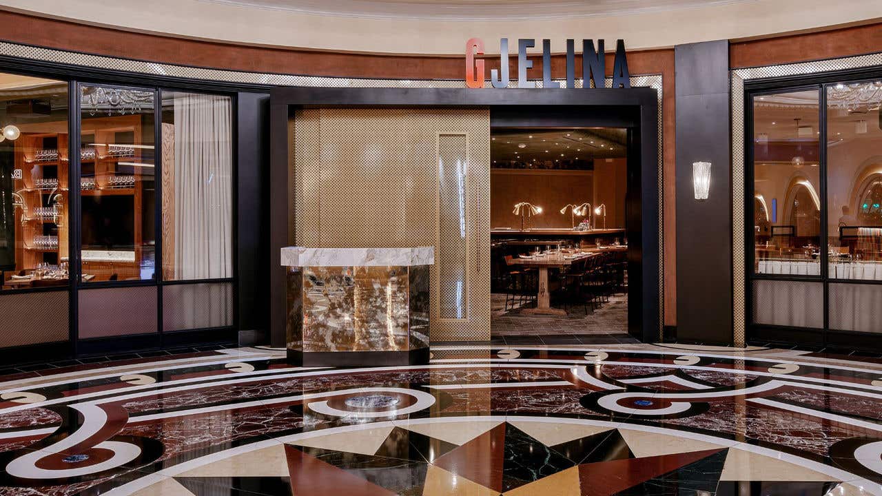 Front entrance of Gjelina restaurant, with a large gold door and a “GJELINA” sign above. 