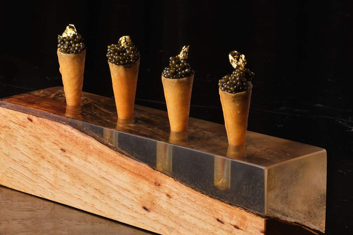 A crispy cone filled with luxurious caviar and topped with a gold leaf. 