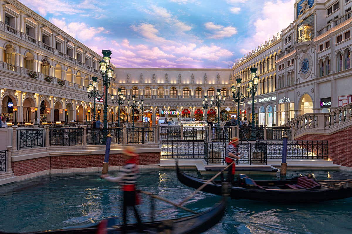An indoor scene with gondolas and Renaissance-style architecture inside St. Mark's Square at The Venetian Resort.